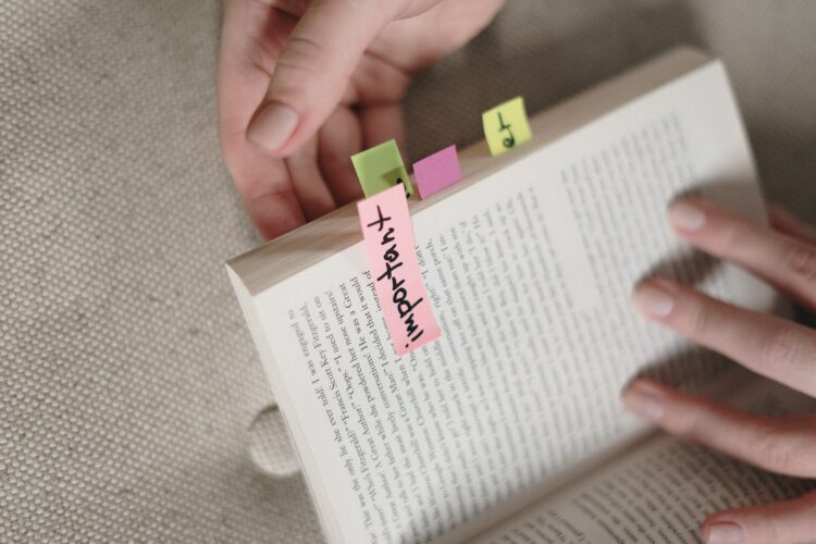 Important sticky note on a book.