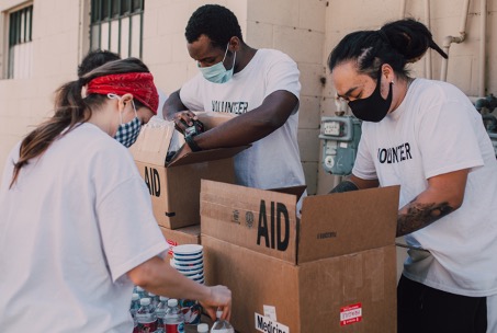 Group of volunteers boxing supplies to help those in need.