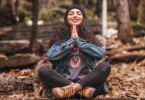 Woman meditating in the woods