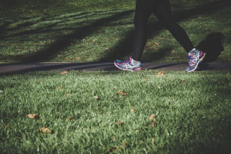 Women in running shoes walking in a park